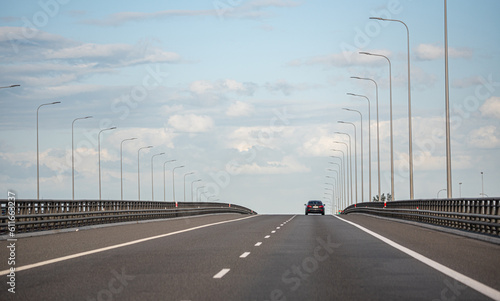Gdansk, Poland - May 26, 2022: Cars on the highway. Expressway in the rays of the setting sun. Asphalt Ribbon. © PhotoRK