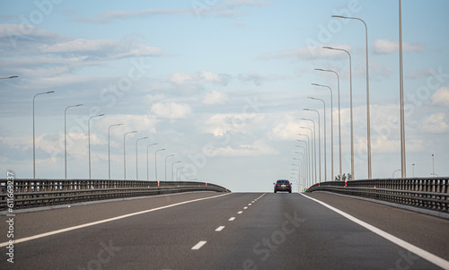 Gdansk, Poland - May 26, 2022: Cars on the highway. Expressway in the rays of the setting sun. Asphalt Ribbon.