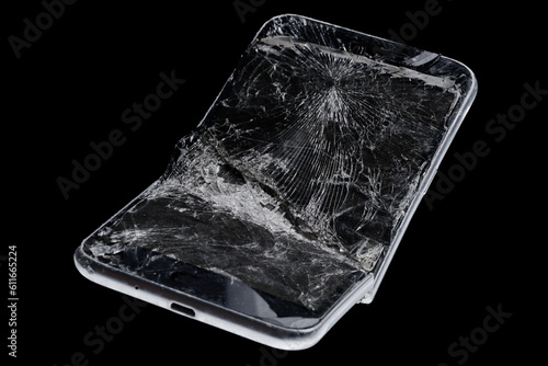 Mobile smartphone with broken screen on black background