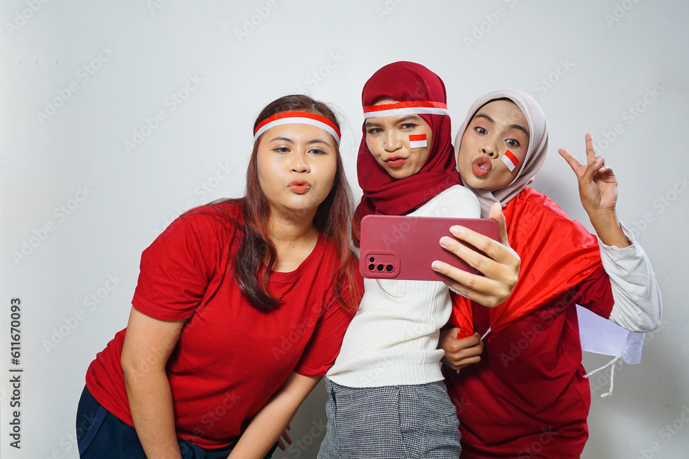 happiness of a group of young people using the red and white attributes to commemorate independence day happiness of a group of young people using the red and white attributes to commemorate independence day
