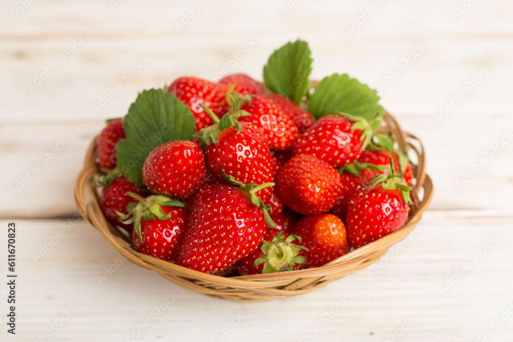 Fresh strawberries in bowl on wooden table Fresh strawberries in bowl on wooden table