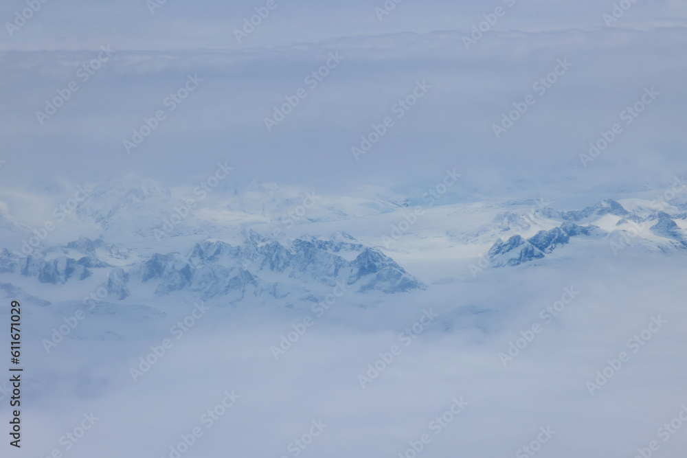 Combination of high altitude snow clouds forms picturesque scenery in Greenland mountain peaks