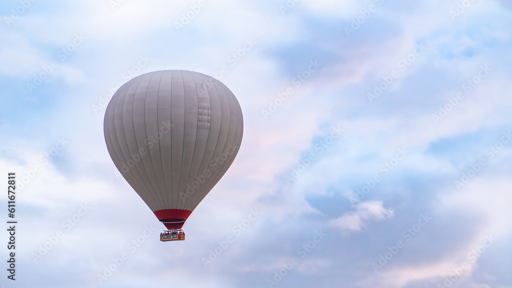 Naklejka premium Cappadocia. Hot air balloons flying over Cappadocia in a dramatic sky. Travel to Turkey. Selective focus included.