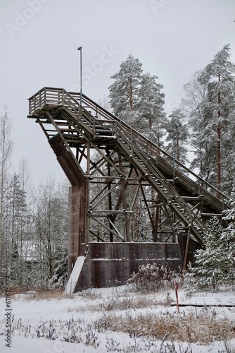 Training wooden ski jumping hill in the middle of the winter snowy forest landscape 