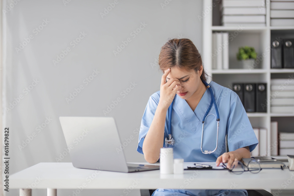 Stressed young female doctor looking at laptop reading bad news online worried of mistake at workplace. Unhappy professional physician in tension feeling tired solving computer problem at work. Stressed young female doctor looking at laptop reading bad news online worried of mistake at workplace. Unhappy professional physician in tension feeling tired solving computer problem at work.