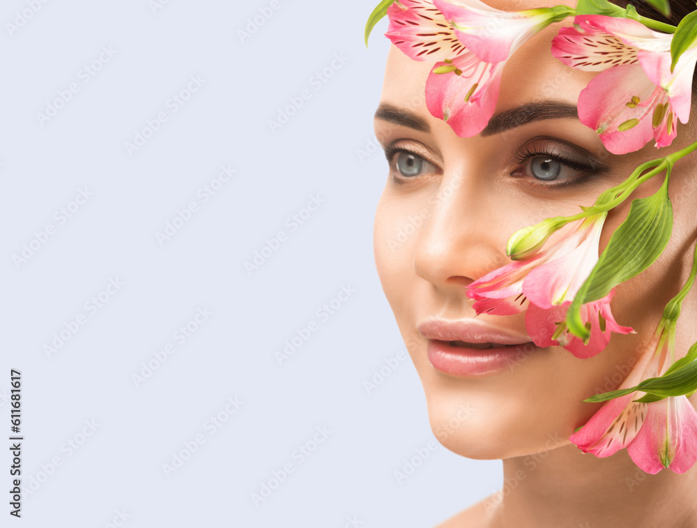 Portrait of attractive girl with healthy clean skin and beautiful make-up. Aesthetic cosmetology and makeup concept.Near her face is a pink flower