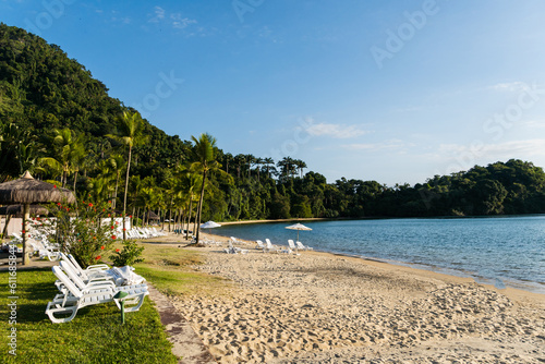 Beautiful beach in Angra do Reis  green coast of Rio de Janeiro. Tangu   Beach. Hills and mountains in the background on a sunny day. Crystal clear water. Late afternoon