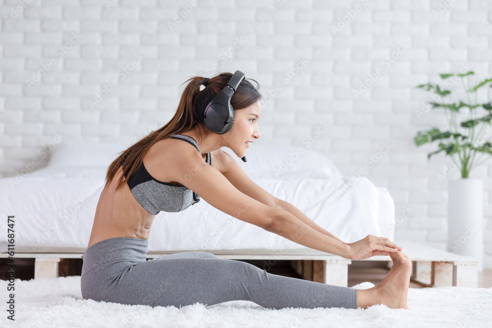 Calm of Asian woman in sportwear stretching muslce to warm up breathing and meditation with yoga at home.Healthy female doing yoga Feeling so comfortable and relax,Wellness Yoga Healthcare Concept Calm of Asian woman in sportwear stretching muslce to warm up breathing and meditation with yoga at home.Healthy female doing yoga Feeling so comfortable and relax,Wellness Yoga Healthcare Concept