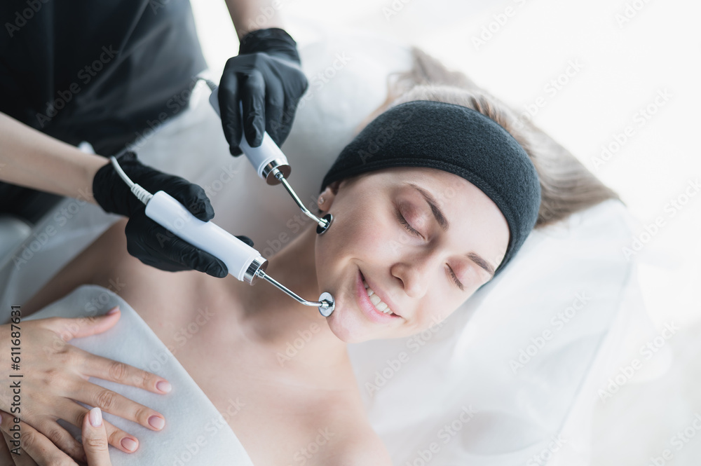 Young caucasian woman on microcurrent therapy procedure. Beautician's office. Young caucasian woman on microcurrent therapy procedure. Beautician's office.
