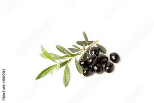Black olives isolated on white background. Olive tree leaves. Vegan. Ingredient for salad or pizza.