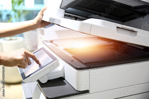 Obraz na plátně Photocopier printer, Close up hand office man press copy button on panel to using the copier or photocopy machine for scanning document or printing paper or Xerox a sheet