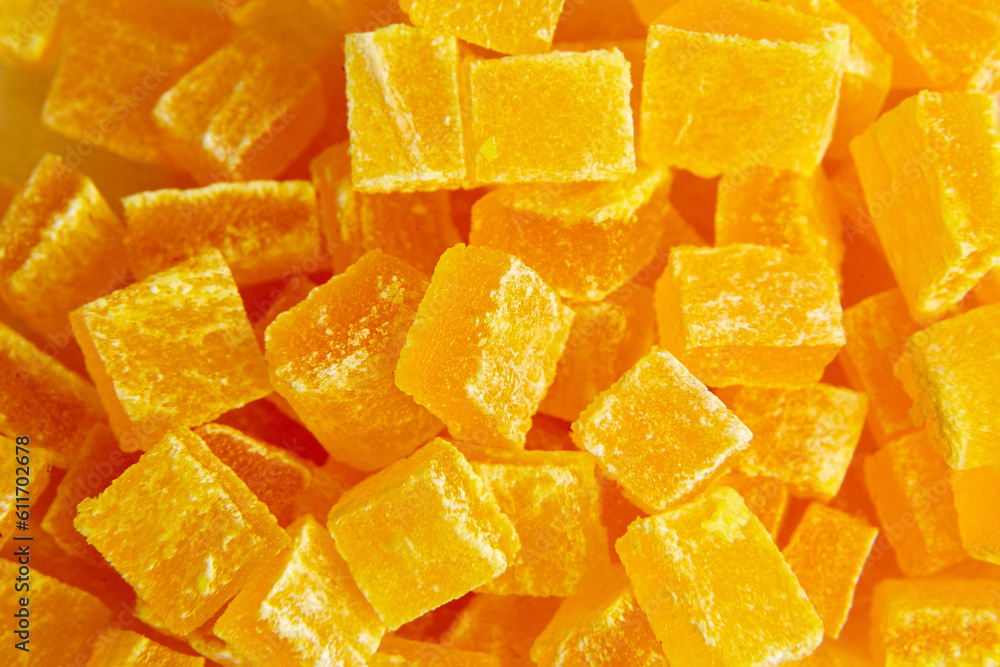 Diced mango dried fruits texture background, top view. Dehydrated mango chips dices, sweet food closeup Diced mango dried fruits texture background, top view. Dehydrated mango chips dices, sweet food closeup