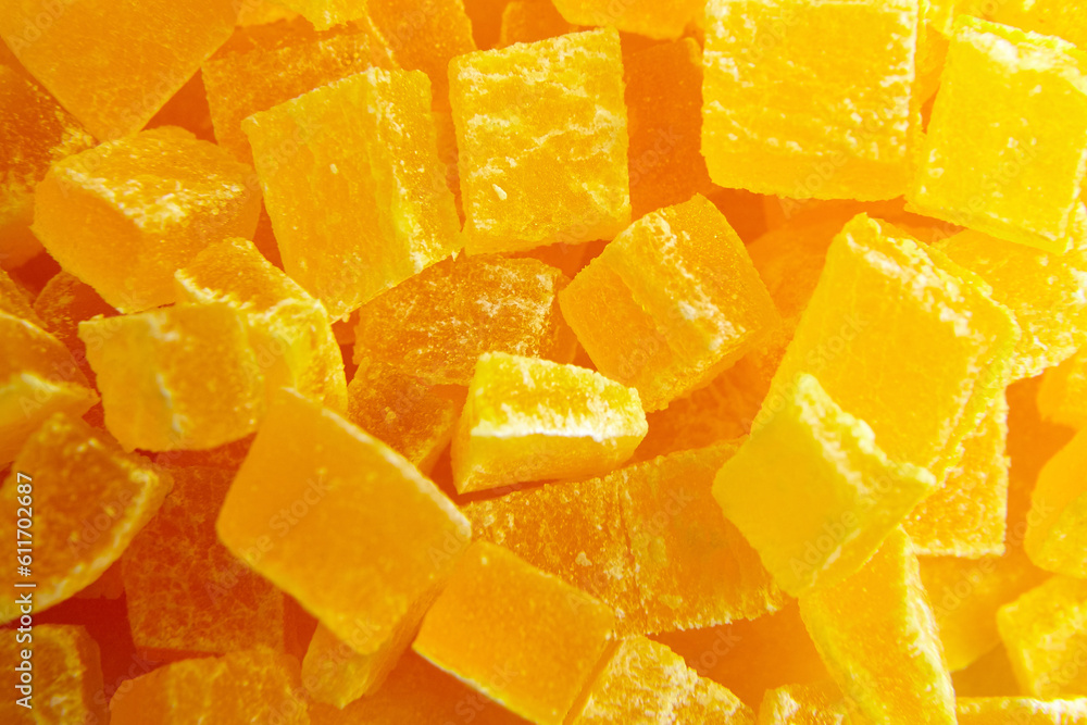 Diced mango dried fruits texture background, top view. Dehydrated mango chips dices, sweet food closeup Diced mango dried fruits texture background, top view. Dehydrated mango chips dices, sweet food closeup
