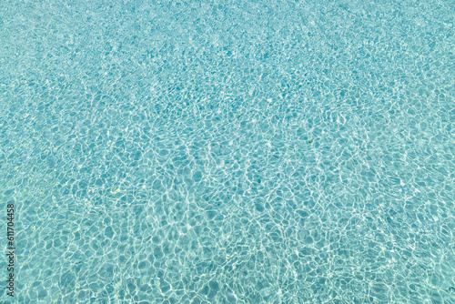 Fototapeta Naklejka Na Ścianę i Meble -  Tropical beach water background. Idyllic texture or crystal clear water surface, transparent sea ocean ecology nature concept. Sunlight, bright water pattern wallpaper