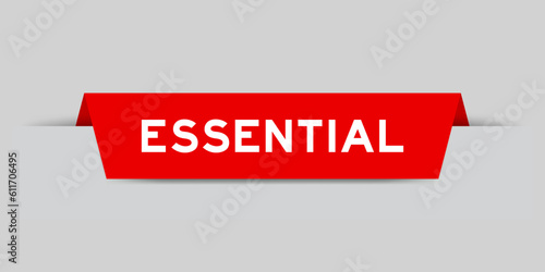 Red color inserted label with word essential on gray background