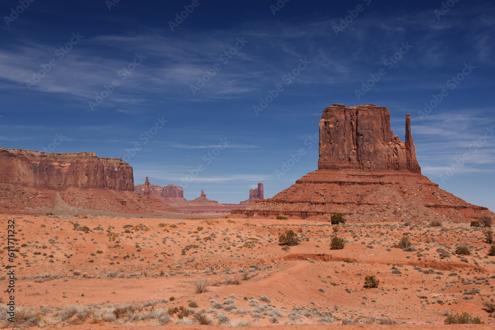 Amazing red rock formations in the Monument Valley, Navajo Tribal Park, Utah, USA. Dry landscape and dramatic clouds.