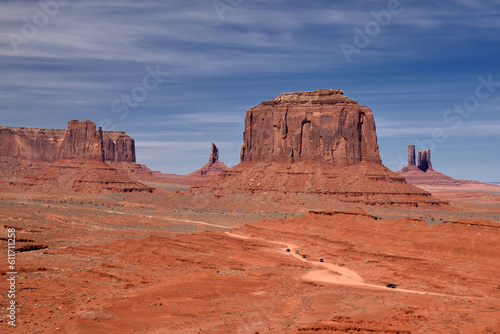 Amazing red rock formations in the Monument Valley, Navajo Tribal Park, Utah, USA. Dry landscape and dramatic clouds.