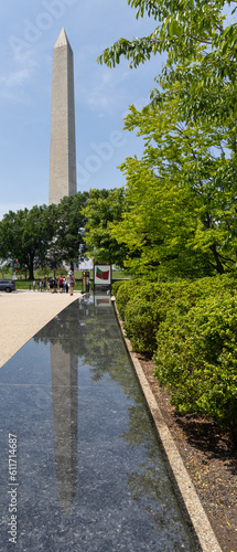Reflection of the Washington Monument on a park bench