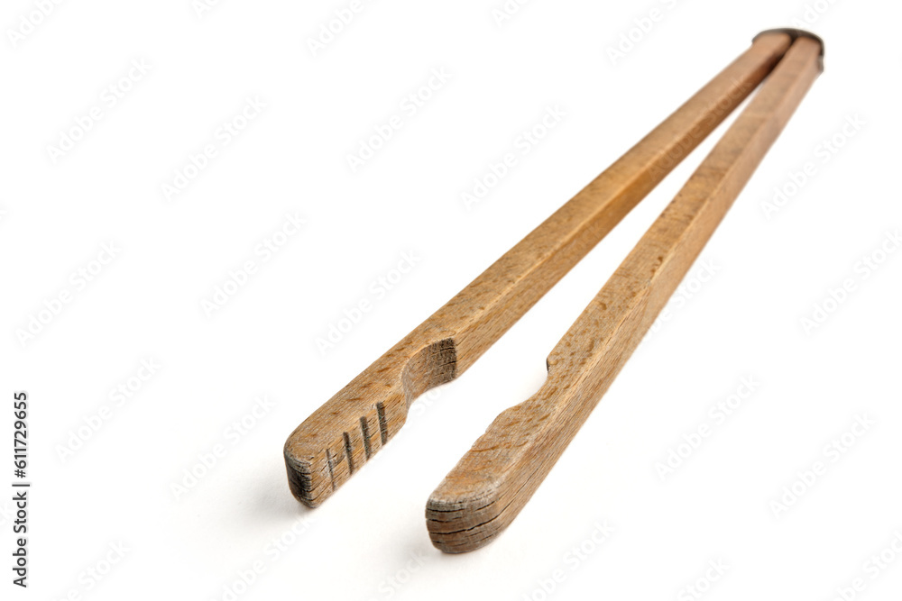 Shabby old wooden tongs for boiling hot washing clothes isolated on white background Shabby old wooden tongs for boiling hot washing clothes isolated on white background
