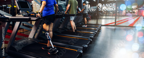 Sports woman with artificial leg running on treadmill at gym. © kanpisut