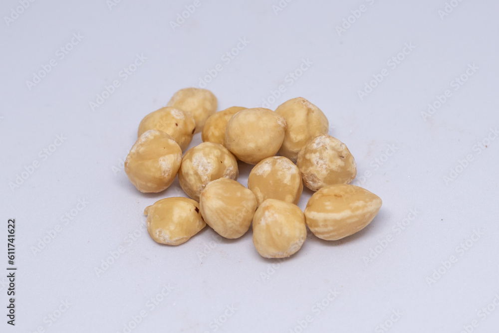 Obraz premium Beautiful hazelnuts are seen harvested on a white background and ready to be consumed.