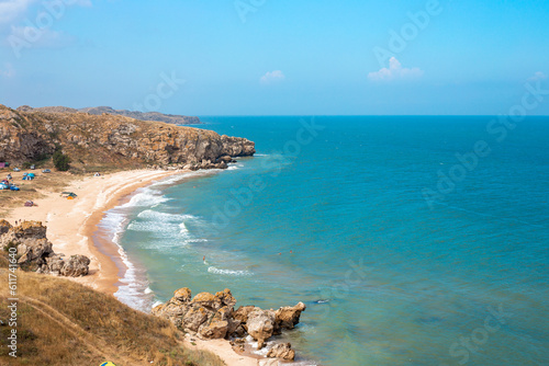 Sea coast with rocky shore and sandy beach. Sea of Azov in Crimea