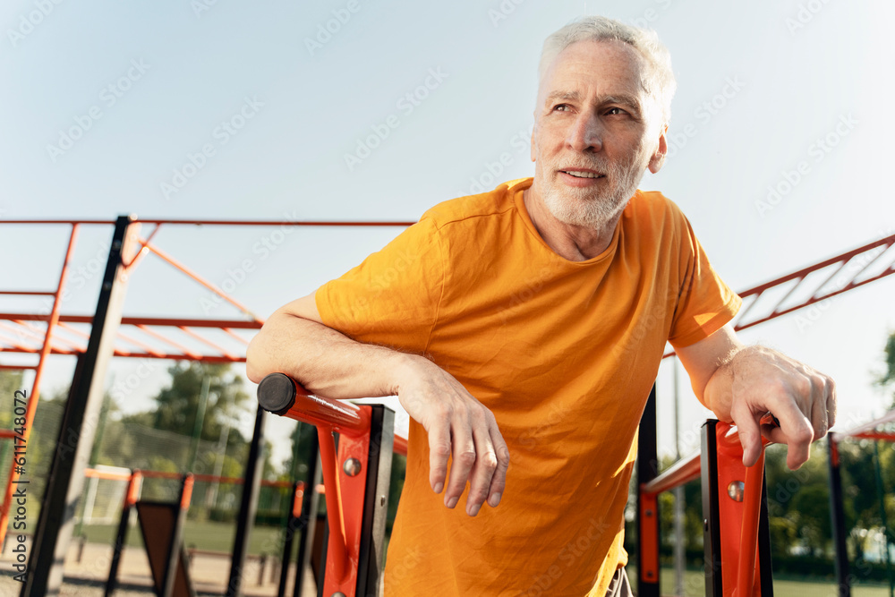 Caucasian senior man, retired strong athlete looking away, relaxing after intense workout