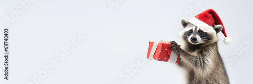 Banner with Cute raccoon in santa hat dances with red gift on white background. Merry Christmas concept. Generative AI © colnihko