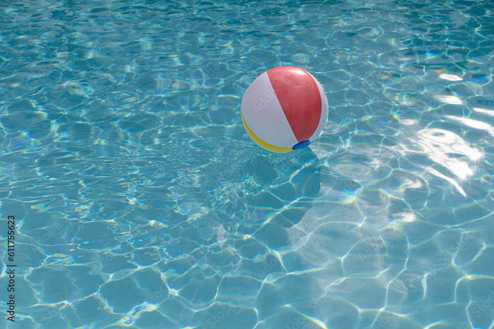 Colorful inflatable ball floating in the pool