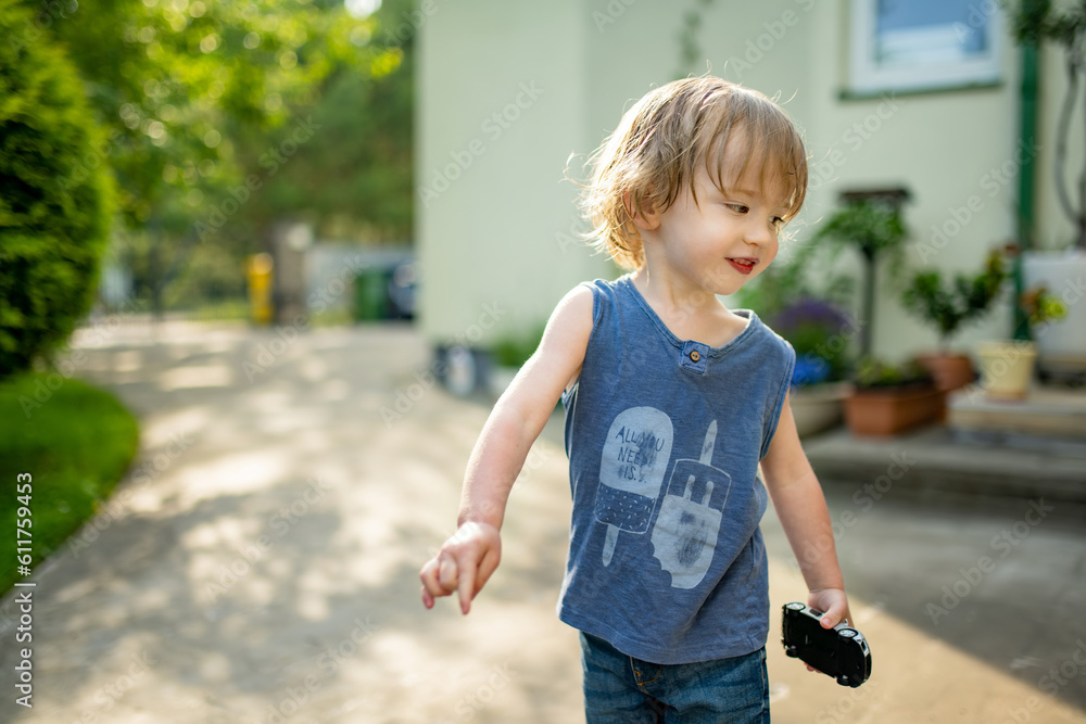 Adorable toddler boy having fun outdoors on sunny summer day. Child exploring nature. Summer activities for kids. Adorable toddler boy having fun outdoors on sunny summer day. Child exploring nature. Summer activities for kids.