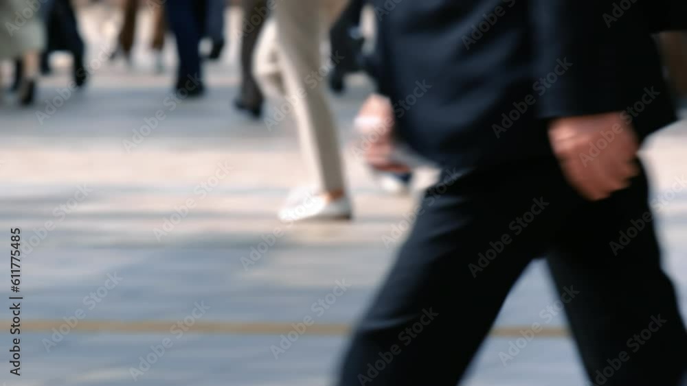 Slow motion of many commuters going to work. Defocus people walking in the street. Slow motion of many commuters going to work. Defocus people walking in the street.