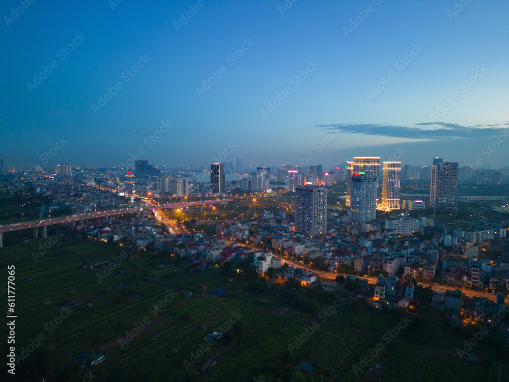 Obraz premium Aerial view of Hanoi Downtown Skyline, Vietnam. Financial district and business centers in smart urban city in Asia. Skyscraper and high-rise buildings at night.