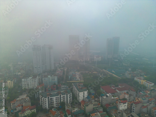 Aerial view of Hanoi Downtown Skyline with fog mist, Vietnam. Financial district and business centers in smart urban city in Asia. Skyscraper and high-rise buildings.