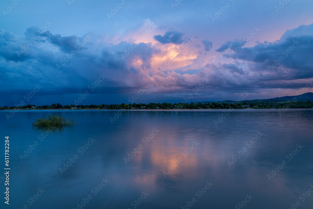 dramatic sunset sky and clouds over Rocky Mountains and lake in northern Colorado dramatic sunset sky and clouds over Rocky Mountains and lake in northern Colorado
