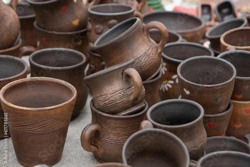 Different examples of tradtional ukrainian clay pottery: pots, jars, vases, cups and bowls.