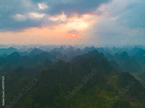 Aerial top view of forest trees and green mountain hills with fog, mist and clouds. Nature landscape background, Vietnam.