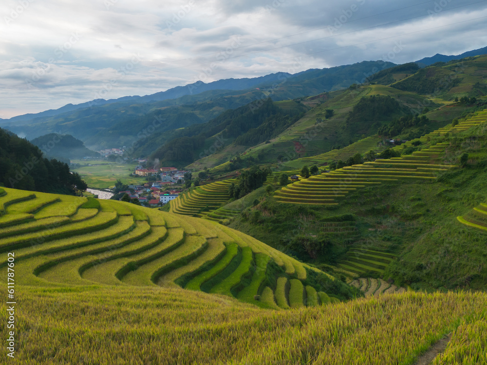 Aerial top view of fresh paddy rice terraces, green agricultural fields in countryside or rural area of Mu Cang Chai, mountain hills valley in Asia, Vietnam. Nature landscape background. Aerial top view of fresh paddy rice terraces, green agricultural fields in countryside or rural area of Mu Cang Chai, mountain hills valley in Asia, Vietnam. Nature landscape background.
