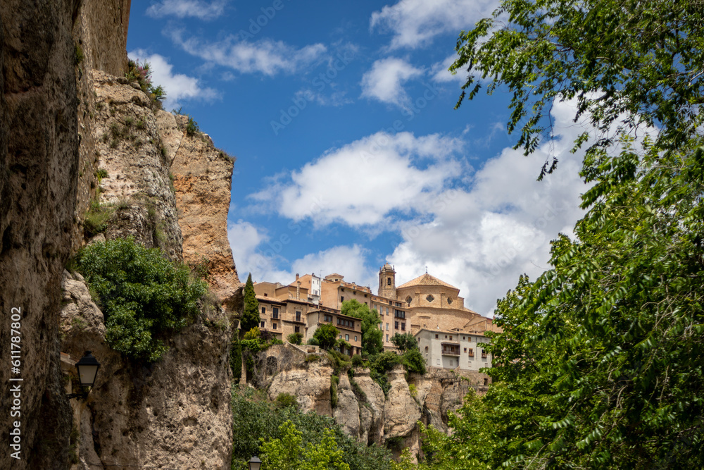 Beautiful partial view between trees and rocks of the Unesco heritage monumental city of Cuenca, Spain