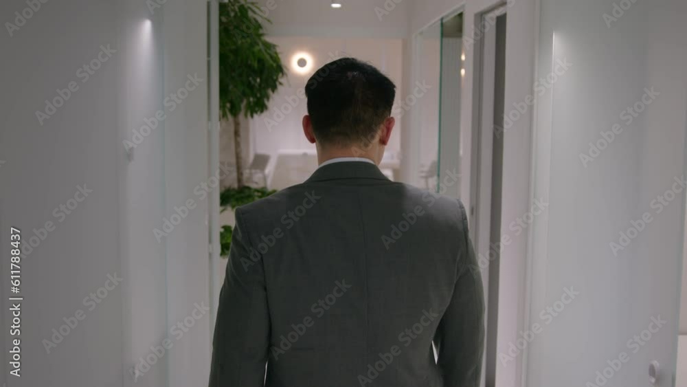 Back view male employee walking on meeting in office corridor professional businessman going in business center company hallway adult CEO employer in formal suit unrecognizable man going alone walk Back view male employee walking on meeting in office corridor professional businessman going in business center company hallway adult CEO employer in formal suit unrecognizable man going alone walk