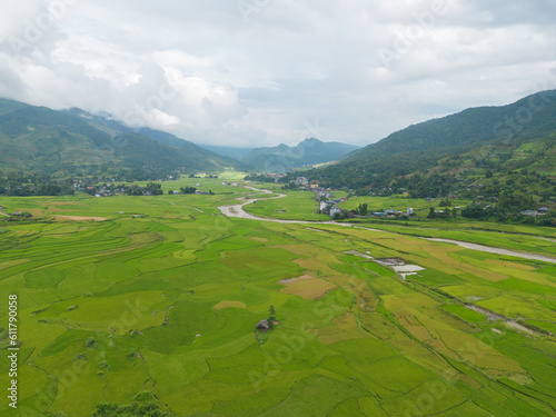 Aerial top view of fresh paddy rice terraces, green agricultural fields in countryside or rural area of Mu Cang Chai, mountain hills valley in Asia, Vietnam. Nature landscape background.