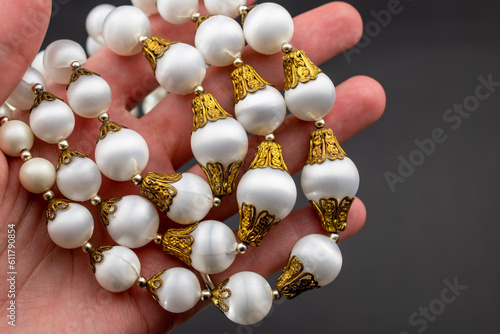 Wallpaper Mural Statement white bead necklace on black background, massive unusual vintage jewelry, promotional photo for an online jewellery store Torontodigital.ca