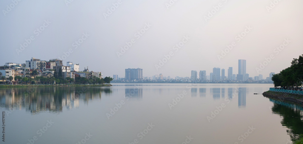 Reflection of Hanoi Downtown Skyline, Vietnam with lake and river. Financial district and business centers in smart urban city in Asia. Skyscraper and high-rise buildings.