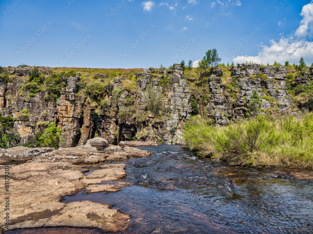 Ngwaritsana river flowing before it drops over the mountain at the Driekop Gorge with blue sky, Mpumalanga, South Africa