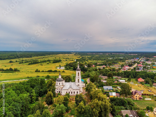 Landscape with orthodox church with fields under gloomy sky