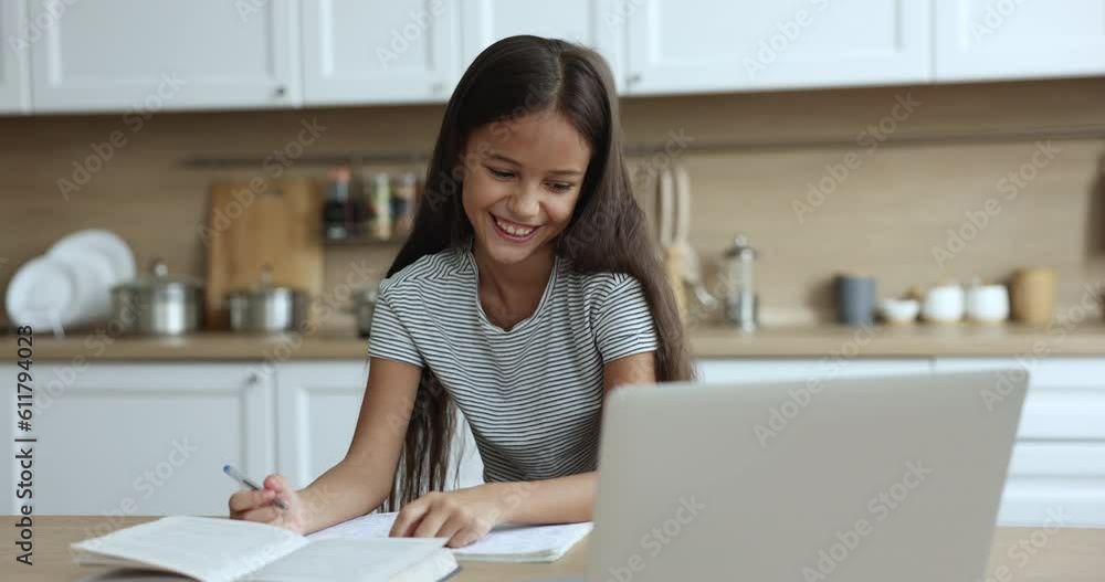 Beautiful schoolgirl studying with on-line tutor, makes assignment using laptop and videocall application. Pretty girl talks to teacher, discuss school task, take part in class. Education, modern tech Beautiful schoolgirl studying with on-line tutor, makes assignment using laptop and videocall application. Pretty girl talks to teacher, discuss school task, take part in class. Education, modern tech