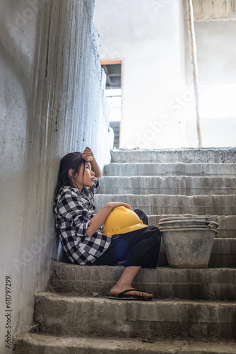 Valokuva Exhausted little girl sitting on stairs floor concrete wall background