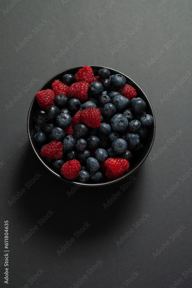 Blueberry Raspberry mixed on dark background Blueberry Raspberry mixed on dark background
