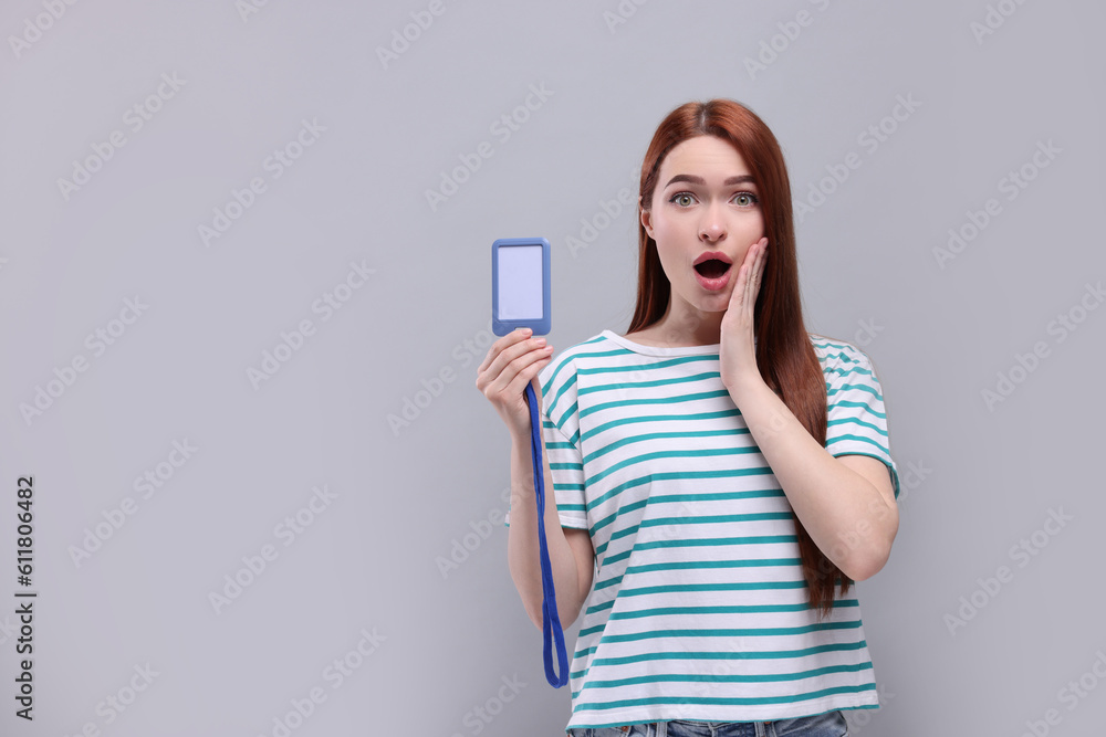 Naklejka premium Shocked woman with vip pass badge on light grey background. Space for text