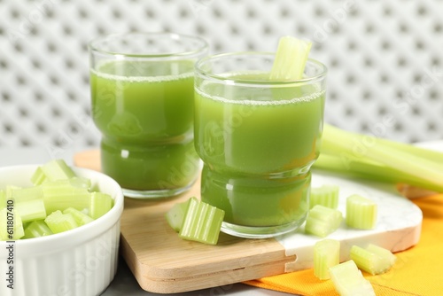 Celery juice and fresh vegetables on table, closeup