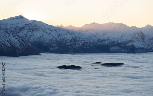 New Zealand winter landscape with snow, mountains, clouds and sunet